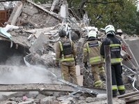 Rescuers work at the scene of an overnight Russian attack in the Novokadatskyi district of Dnipro, Ukraine, on October 25, 2024. NO USE RUSS...