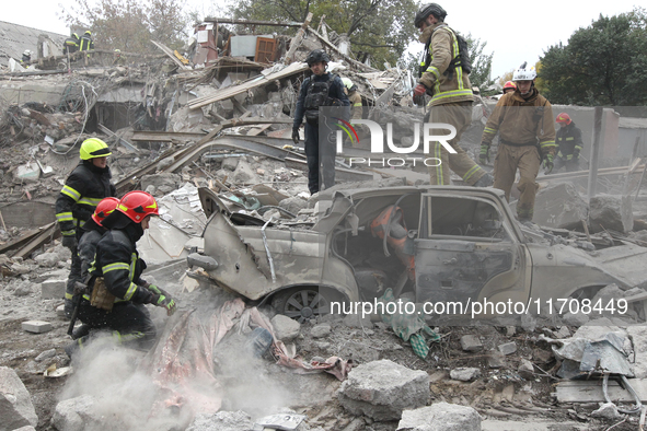 Rescuers work at the scene of an overnight Russian attack in the Novokadatskyi district of Dnipro, Ukraine, on October 25, 2024. NO USE RUSS...