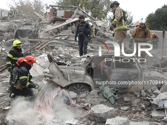 Rescuers work at the scene of an overnight Russian attack in the Novokadatskyi district of Dnipro, Ukraine, on October 25, 2024. NO USE RUSS...