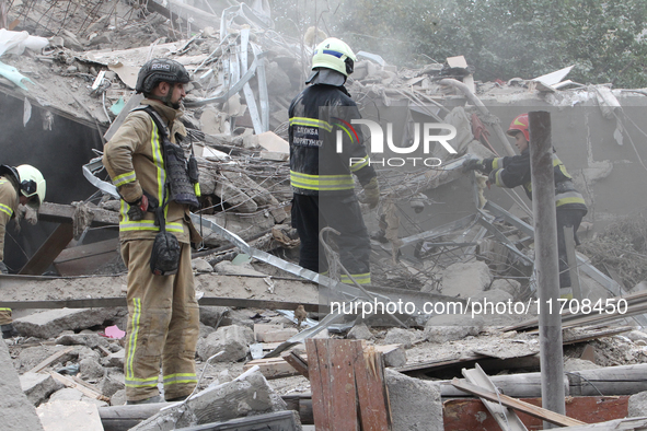 Rescuers work at the scene of an overnight Russian attack in the Novokadatskyi district of Dnipro, Ukraine, on October 25, 2024. NO USE RUSS...