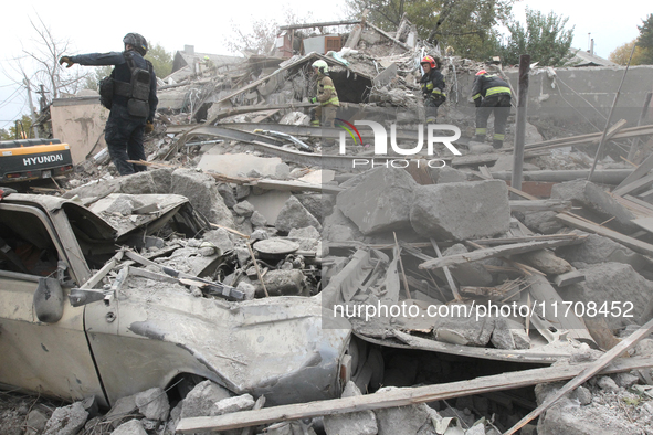 Rescuers work at the scene of an overnight Russian attack in the Novokadatskyi district of Dnipro, Ukraine, on October 25, 2024. NO USE RUSS...