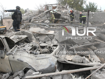 Rescuers work at the scene of an overnight Russian attack in the Novokadatskyi district of Dnipro, Ukraine, on October 25, 2024. NO USE RUSS...