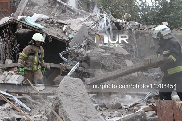 Rescuers work at the scene of an overnight Russian attack in the Novokadatskyi district of Dnipro, Ukraine, on October 25, 2024. NO USE RUSS...