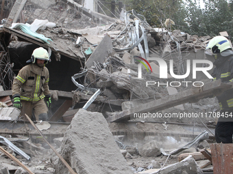 Rescuers work at the scene of an overnight Russian attack in the Novokadatskyi district of Dnipro, Ukraine, on October 25, 2024. NO USE RUSS...