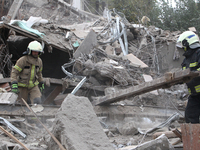 Rescuers work at the scene of an overnight Russian attack in the Novokadatskyi district of Dnipro, Ukraine, on October 25, 2024. NO USE RUSS...