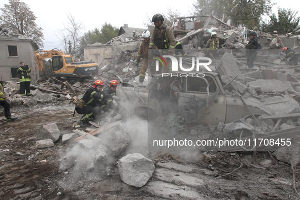 Rescuers work at the scene of an overnight Russian attack in the Novokadatskyi district of Dnipro, Ukraine, on October 25, 2024. NO USE RUSS...