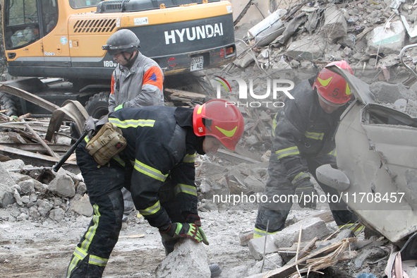 Rescuers work at the scene of an overnight Russian attack in the Novokadatskyi district of Dnipro, Ukraine, on October 25, 2024. NO USE RUSS...