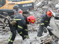 Rescuers work at the scene of an overnight Russian attack in the Novokadatskyi district of Dnipro, Ukraine, on October 25, 2024. NO USE RUSS...