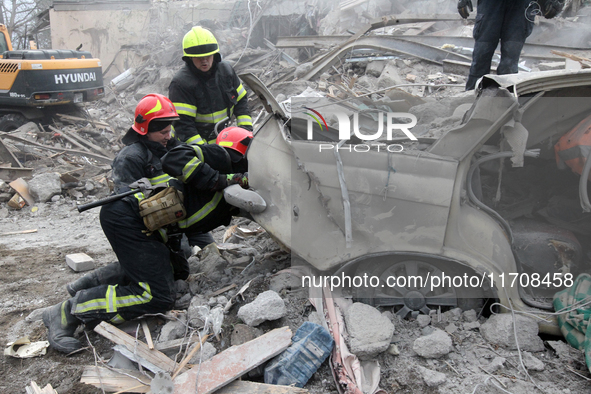 Rescuers work at the scene of an overnight Russian attack in the Novokadatskyi district of Dnipro, Ukraine, on October 25, 2024. NO USE RUSS...