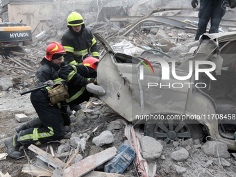 Rescuers work at the scene of an overnight Russian attack in the Novokadatskyi district of Dnipro, Ukraine, on October 25, 2024. NO USE RUSS...