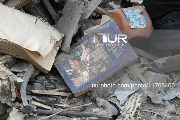 A book is on the ruins of a building destroyed by an overnight Russian attack in the Novokadatskyi district of Dnipro, Ukraine, on October 2...