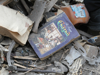 A book is on the ruins of a building destroyed by an overnight Russian attack in the Novokadatskyi district of Dnipro, Ukraine, on October 2...