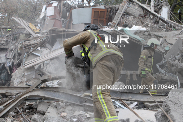 Rescuers work at the scene of an overnight Russian attack in the Novokadatskyi district of Dnipro, Ukraine, on October 25, 2024. NO USE RUSS...