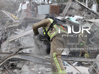 Rescuers work at the scene of an overnight Russian attack in the Novokadatskyi district of Dnipro, Ukraine, on October 25, 2024. NO USE RUSS...