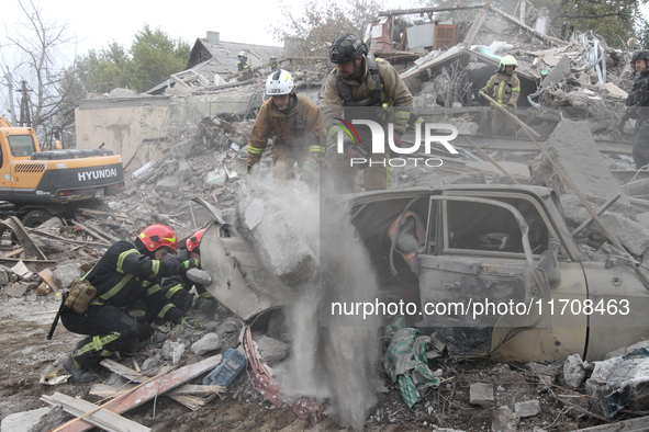 Rescuers work at the scene of an overnight Russian attack in the Novokadatskyi district of Dnipro, Ukraine, on October 25, 2024. NO USE RUSS...