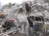 Rescuers work at the scene of an overnight Russian attack in the Novokadatskyi district of Dnipro, Ukraine, on October 25, 2024. NO USE RUSS...