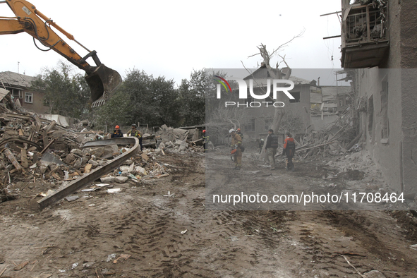 Rescuers work at the scene of an overnight Russian attack in the Novokadatskyi district of Dnipro, Ukraine, on October 25, 2024. NO USE RUSS...