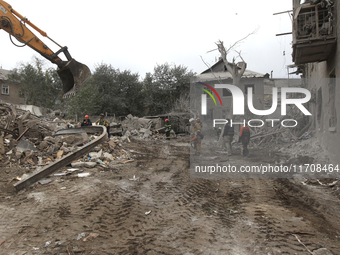 Rescuers work at the scene of an overnight Russian attack in the Novokadatskyi district of Dnipro, Ukraine, on October 25, 2024. NO USE RUSS...