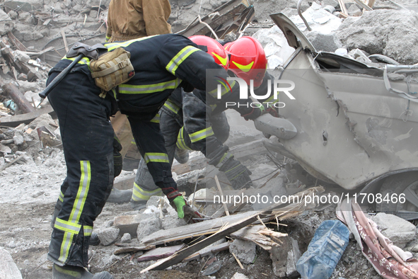 Rescuers work at the scene of an overnight Russian attack in the Novokadatskyi district of Dnipro, Ukraine, on October 25, 2024. NO USE RUSS...