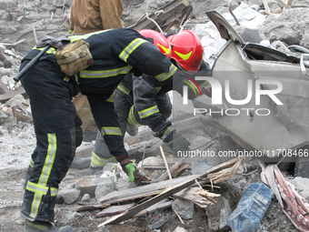 Rescuers work at the scene of an overnight Russian attack in the Novokadatskyi district of Dnipro, Ukraine, on October 25, 2024. NO USE RUSS...