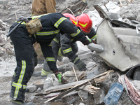 Rescuers work at the scene of an overnight Russian attack in the Novokadatskyi district of Dnipro, Ukraine, on October 25, 2024. NO USE RUSS...