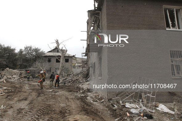 Rescuers work at the scene of an overnight Russian attack in the Novokadatskyi district of Dnipro, Ukraine, on October 25, 2024. NO USE RUSS...