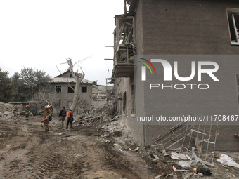 Rescuers work at the scene of an overnight Russian attack in the Novokadatskyi district of Dnipro, Ukraine, on October 25, 2024. NO USE RUSS...