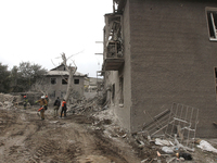 Rescuers work at the scene of an overnight Russian attack in the Novokadatskyi district of Dnipro, Ukraine, on October 25, 2024. NO USE RUSS...