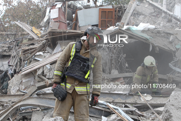 Rescuers work at the scene of an overnight Russian attack in the Novokadatskyi district of Dnipro, Ukraine, on October 25, 2024. NO USE RUSS...