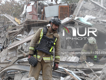 Rescuers work at the scene of an overnight Russian attack in the Novokadatskyi district of Dnipro, Ukraine, on October 25, 2024. NO USE RUSS...