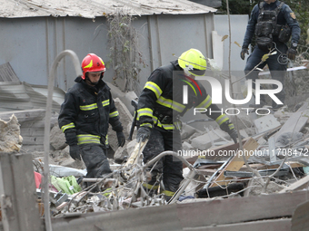 Rescuers work at the scene of an overnight Russian attack in the Novokadatskyi district of Dnipro, Ukraine, on October 25, 2024. NO USE RUSS...