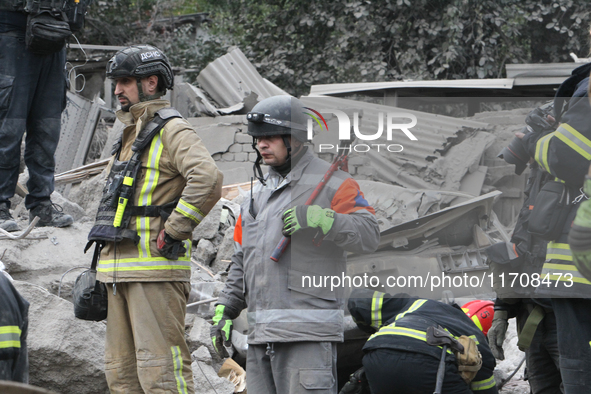 Rescuers work at the scene of an overnight Russian attack in the Novokadatskyi district of Dnipro, Ukraine, on October 25, 2024. NO USE RUSS...