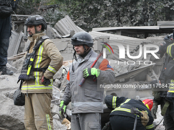 Rescuers work at the scene of an overnight Russian attack in the Novokadatskyi district of Dnipro, Ukraine, on October 25, 2024. NO USE RUSS...