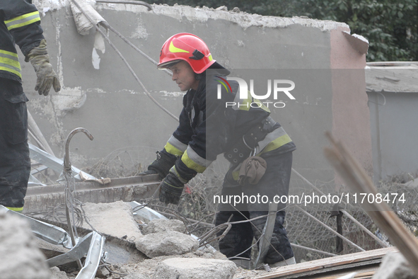 Rescuers work at the scene of an overnight Russian attack in the Novokadatskyi district of Dnipro, Ukraine, on October 25, 2024. NO USE RUSS...