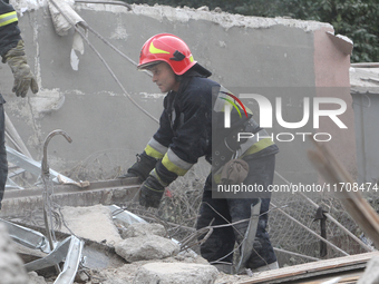 Rescuers work at the scene of an overnight Russian attack in the Novokadatskyi district of Dnipro, Ukraine, on October 25, 2024. NO USE RUSS...