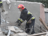 Rescuers work at the scene of an overnight Russian attack in the Novokadatskyi district of Dnipro, Ukraine, on October 25, 2024. NO USE RUSS...