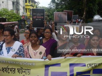 Female activists participate in a rally protest to condemn the rape and murder of a PGT Doctor as they shout slogans against the West Bengal...