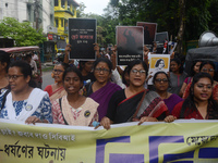 Female activists participate in a rally protest to condemn the rape and murder of a PGT Doctor as they shout slogans against the West Bengal...