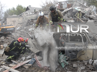 Rescuers work at the scene of an overnight Russian attack in the Novokadatskyi district of Dnipro, Ukraine, on October 26, 2024. NO USE RUSS...