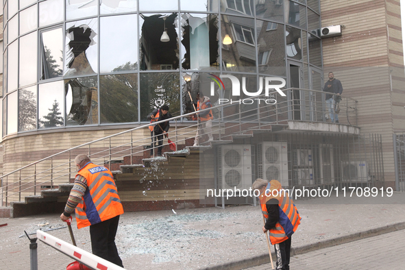 Utility workers sweep away glass shards after a Russian strike on central Dnipro in Dnipro, Ukraine, on October 26, 2024. NO USE RUSSIA. NO...