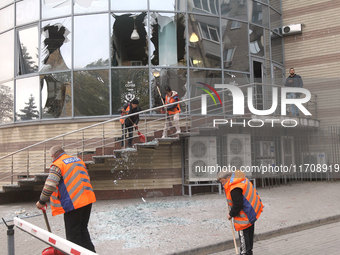 Utility workers sweep away glass shards after a Russian strike on central Dnipro in Dnipro, Ukraine, on October 26, 2024. NO USE RUSSIA. NO...