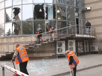 Utility workers sweep away glass shards after a Russian strike on central Dnipro in Dnipro, Ukraine, on October 26, 2024. NO USE RUSSIA. NO...