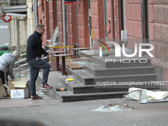 Women sweep away grass shards outside a shop after a Russian strike in Dnipro, Ukraine, on October 26, 2024. NO USE RUSSIA. NO USE BELARUS....