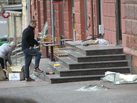 Women sweep away grass shards outside a shop after a Russian strike in Dnipro, Ukraine, on October 26, 2024. NO USE RUSSIA. NO USE BELARUS....