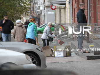 Women sweep away grass shards outside a shop after a Russian strike in Dnipro, Ukraine, on October 26, 2024. NO USE RUSSIA. NO USE BELARUS....