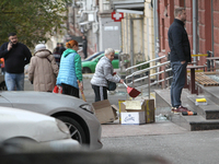 Women sweep away grass shards outside a shop after a Russian strike in Dnipro, Ukraine, on October 26, 2024. NO USE RUSSIA. NO USE BELARUS....