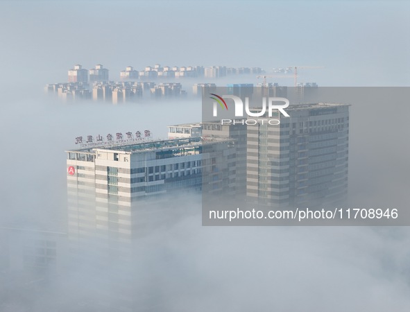 Buildings and real estate projects are seen in advection fog in Yantai, Shandong province, China, on October 26, 2024. 