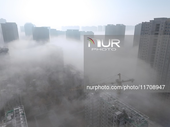 Buildings and real estate projects are seen in advection fog in Yantai, Shandong province, China, on October 26, 2024. 