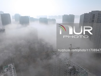 Buildings and real estate projects are seen in advection fog in Yantai, Shandong province, China, on October 26, 2024. (