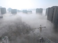 Buildings and real estate projects are seen in advection fog in Yantai, Shandong province, China, on October 26, 2024. (